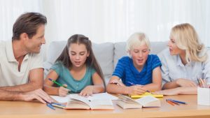 Parents helping their children doing their homework